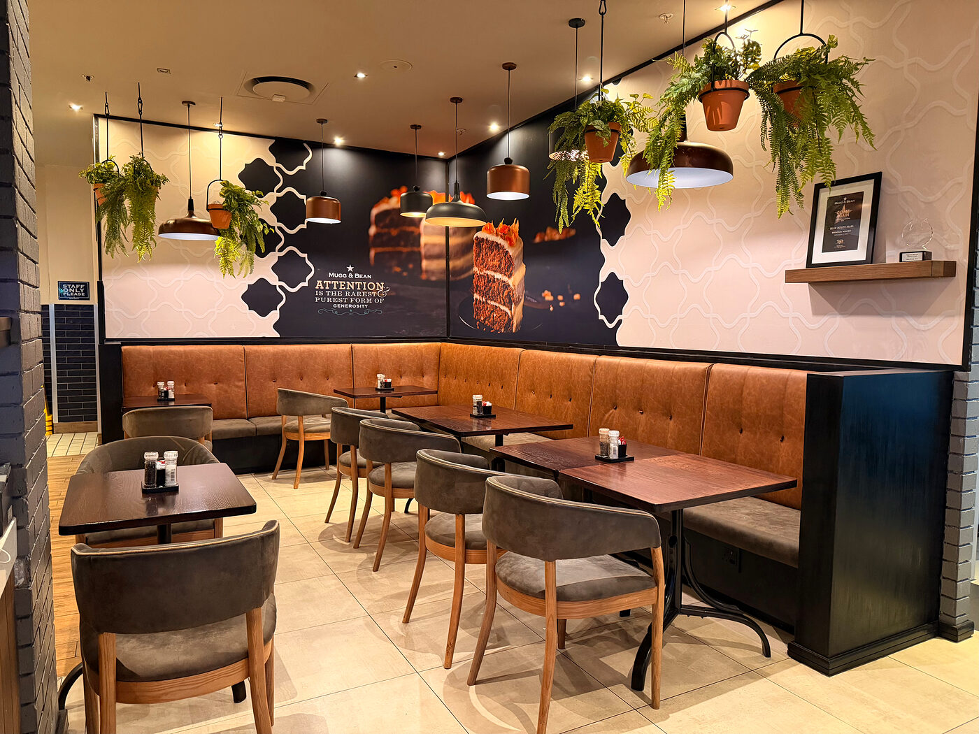 Booth seating and tables in the dining area at Mugg & Bean Blue Route